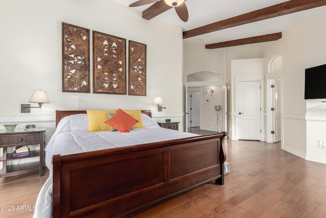 2058 E Marlene Dr, Gilbert, AZ 85296 - bedroom featuring wood finished floors, beam ceiling, ceiling fan, and arched walkways