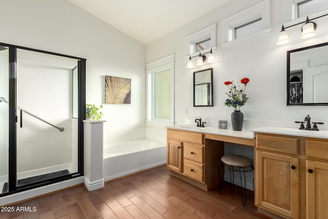 2058 E Marlene Dr, Gilbert, AZ 85296 - full bath with double vanity, a garden tub, wood finished floors, and vaulted ceiling