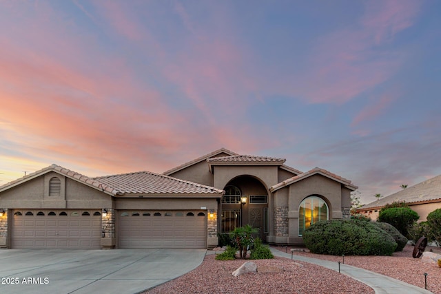 2058 E Marlene Dr, Gilbert, AZ 85296 - mediterranean / spanish-style house featuring stucco siding, a garage, concrete driveway, and stone siding