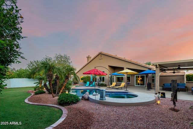 2058 E Marlene Dr, Gilbert, AZ 85296 - pool at dusk featuring ceiling fan, a patio area, a fenced backyard, an in-ground hot tub, and an outdoor living space