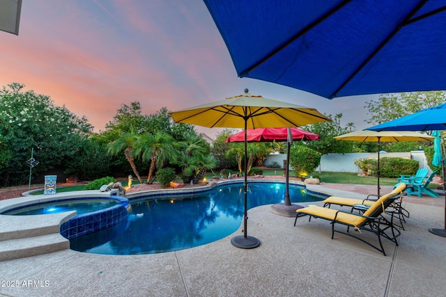 2058 E Marlene Dr, Gilbert, AZ 85296 - pool at dusk featuring a pool with connected hot tub, a patio area, and a fenced backyard