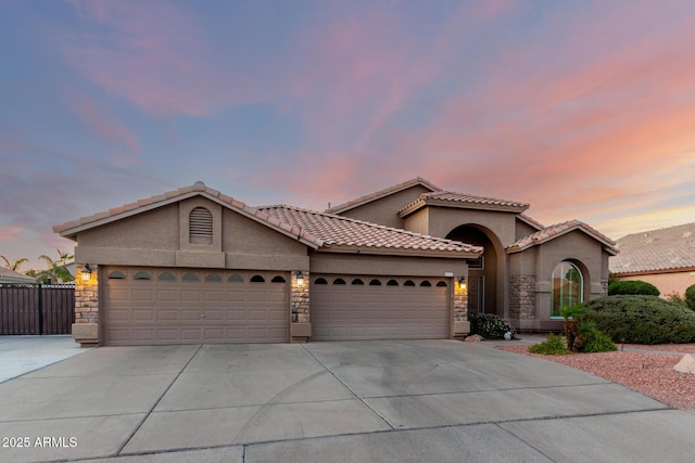2058 E Marlene Dr, Gilbert, AZ 85296 - view of front of home with driveway, an attached garage, stucco siding, and stone siding