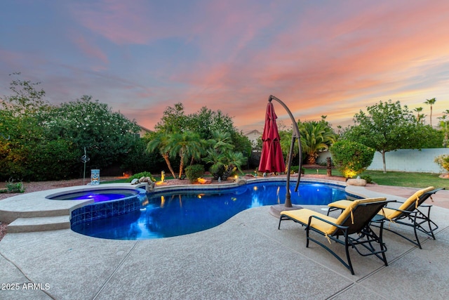 2058 E Marlene Dr, Gilbert, AZ 85296 - pool at dusk with a patio, a fenced backyard, and a pool with connected hot tub
