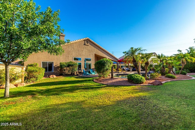 2058 E Marlene Dr, Gilbert, AZ 85296 - back of property featuring a chimney, stucco siding, a lawn, and a patio area