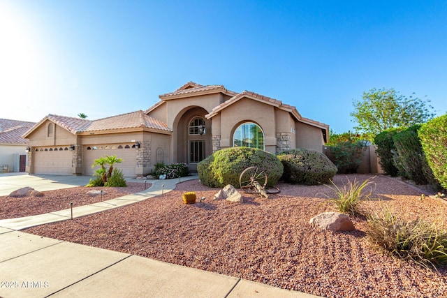 2058 E Marlene Dr, Gilbert, AZ 85296 - mediterranean / spanish house with stucco siding, a tile roof, an attached garage, concrete driveway, and stone siding