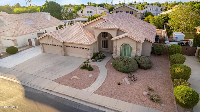 2058 E Marlene Dr, Gilbert, AZ 85296 - mediterranean / spanish-style house with an attached garage, stucco siding, a tiled roof, driveway, and a residential view