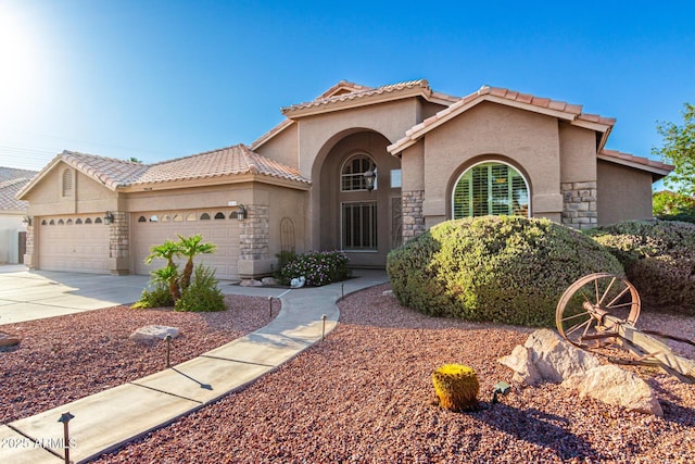 2058 E Marlene Dr, Gilbert, AZ 85296 - mediterranean / spanish house with stucco siding, stone siding, an attached garage, and driveway