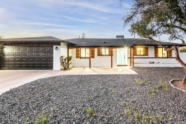 ranch-style home featuring a garage