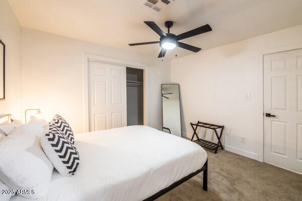 bedroom with carpet floors, a closet, and ceiling fan