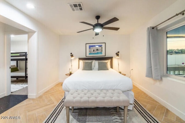 bedroom with ceiling fan and parquet floors