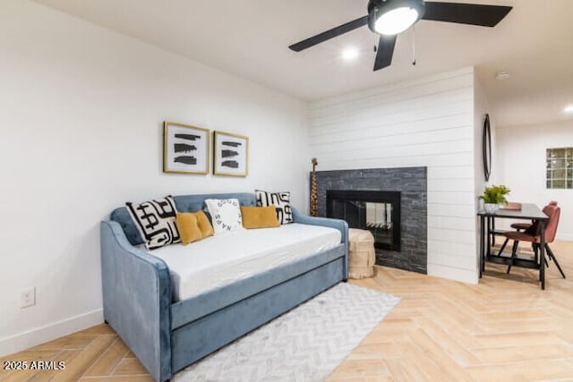 bedroom featuring a multi sided fireplace, parquet floors, and ceiling fan