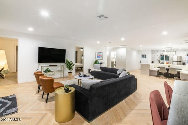 living room with light parquet flooring and ceiling fan