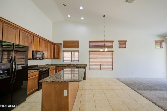 kitchen featuring high vaulted ceiling, a center island, dark stone counters, light tile patterned floors, and black appliances