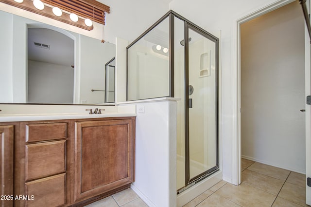 full bath featuring visible vents, vanity, tile patterned floors, and a shower stall