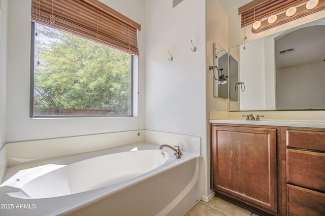full bathroom featuring a healthy amount of sunlight, a garden tub, and visible vents