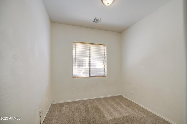 carpeted spare room with baseboards and visible vents