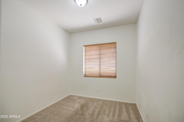 spare room featuring visible vents, carpet flooring, and baseboards