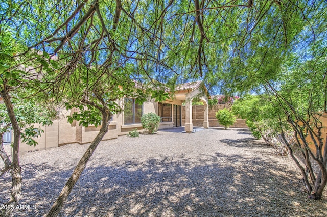 view of front of house with fence and stucco siding
