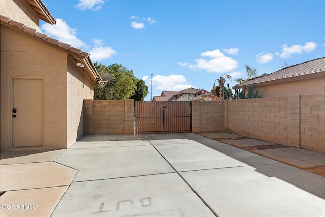 view of patio / terrace featuring fence and a gate