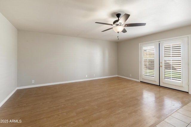 unfurnished room featuring light wood-style floors, french doors, baseboards, and a ceiling fan