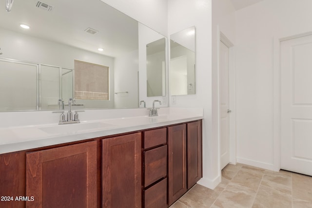 bathroom featuring walk in shower and vanity