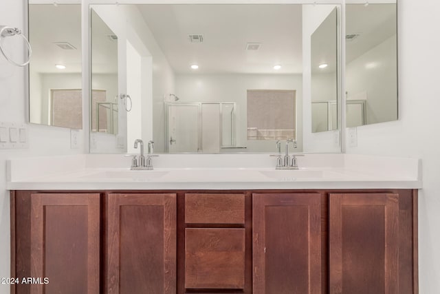 bathroom featuring an enclosed shower and vanity