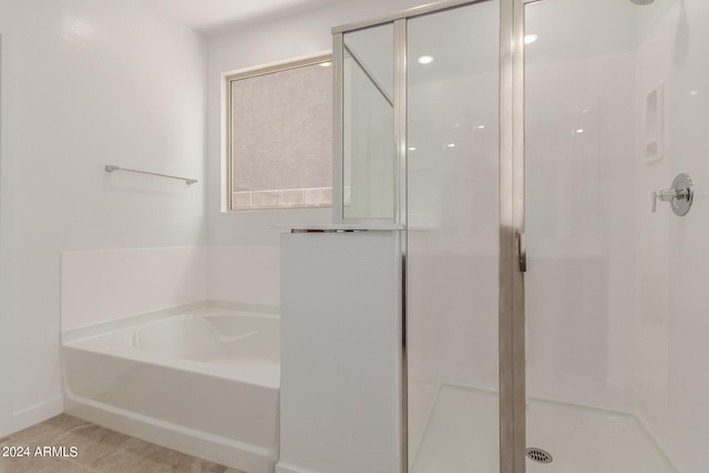 bathroom with shower with separate bathtub