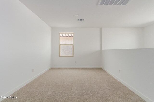 spare room with light carpet