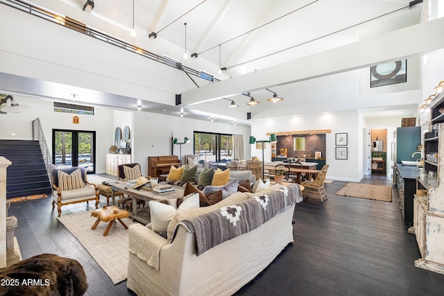 living room featuring dark wood-type flooring, plenty of natural light, french doors, and high vaulted ceiling