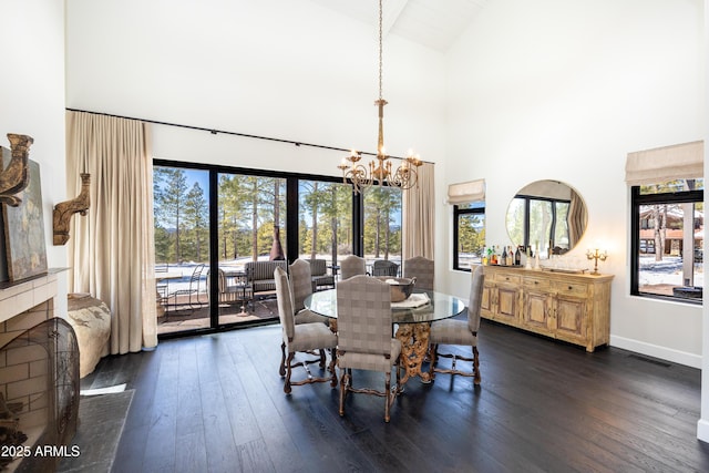 dining area featuring dark wood finished floors, an inviting chandelier, visible vents, and baseboards