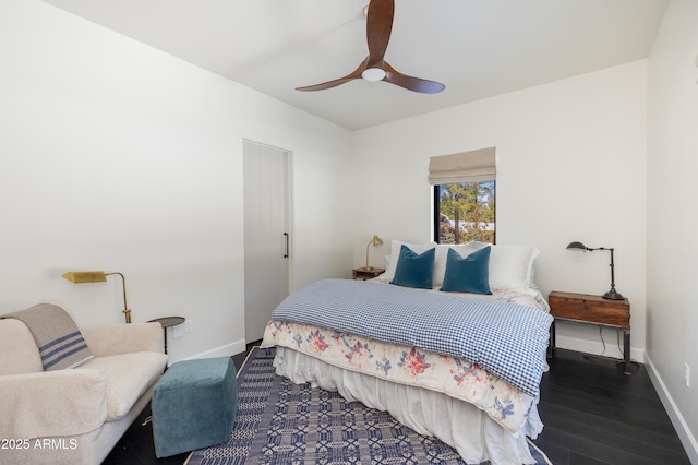 bedroom featuring wood finished floors, baseboards, and ceiling fan