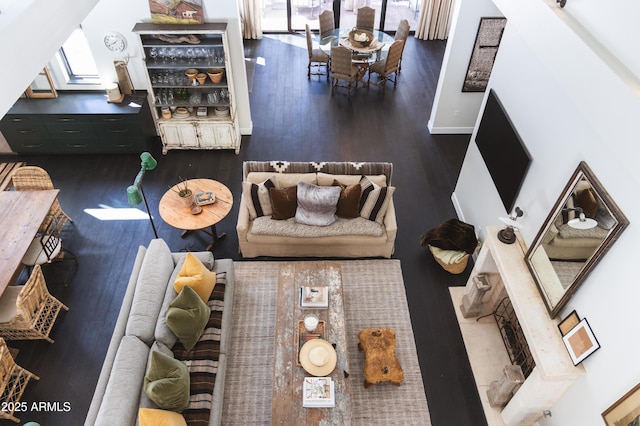 living room with a skylight, baseboards, and wood finished floors