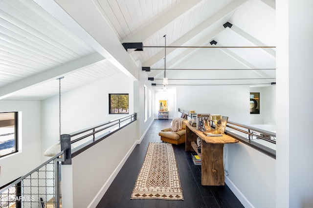 corridor featuring hardwood / wood-style flooring, vaulted ceiling with beams, an upstairs landing, and baseboards