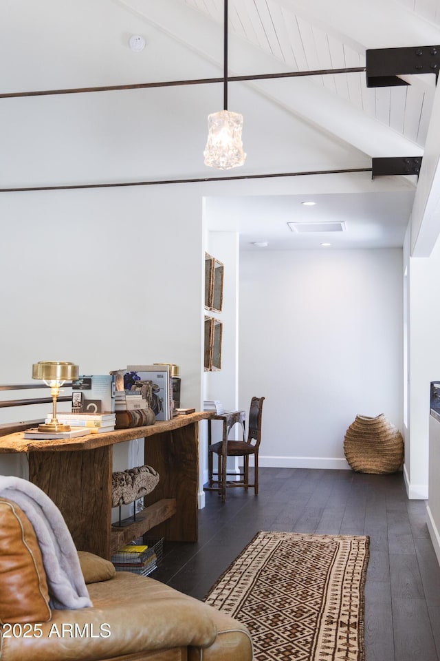 living area featuring lofted ceiling with beams, baseboards, and dark wood-type flooring