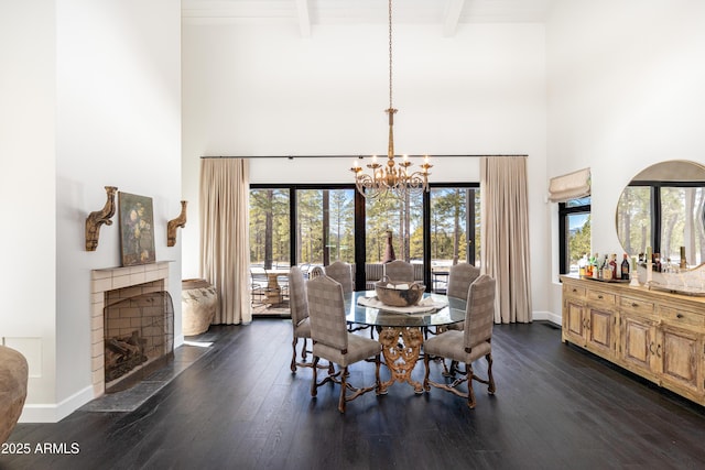 dining room featuring baseboards, beam ceiling, dark wood-type flooring, and an inviting chandelier