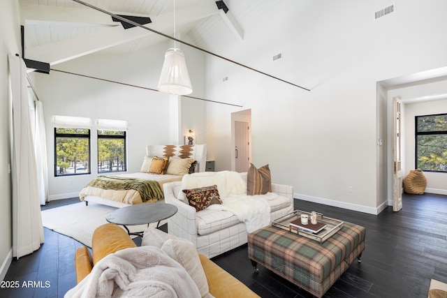 bedroom with hardwood / wood-style floors, baseboards, visible vents, and high vaulted ceiling