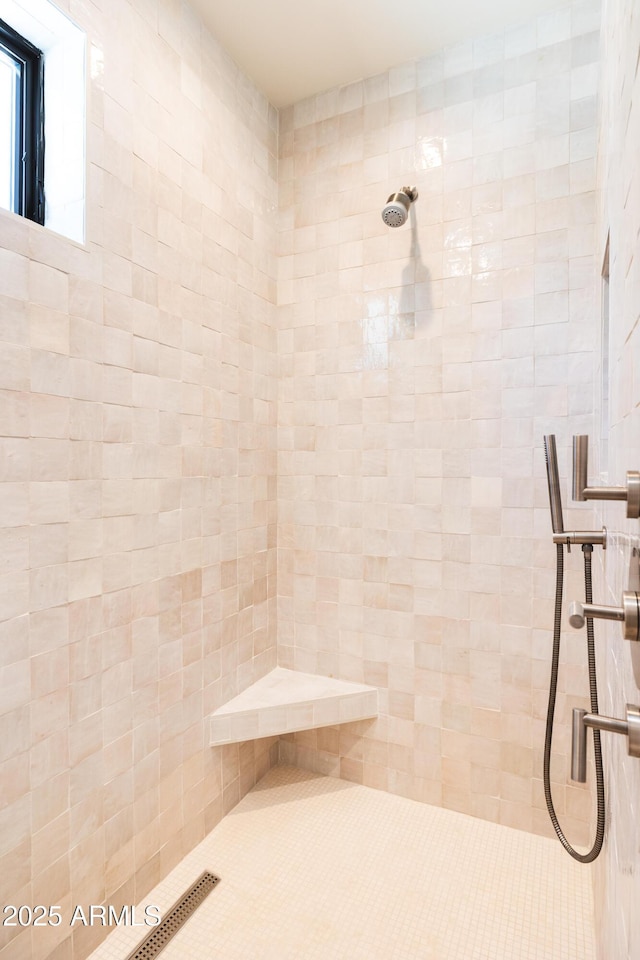 full bath featuring a tile shower