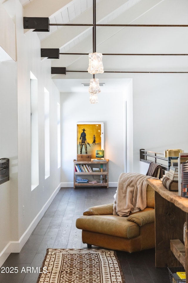 interior space featuring vaulted ceiling with beams, baseboards, wood-type flooring, and a chandelier