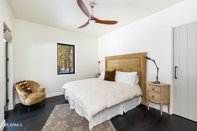 bedroom featuring ceiling fan, baseboards, and dark wood-style floors