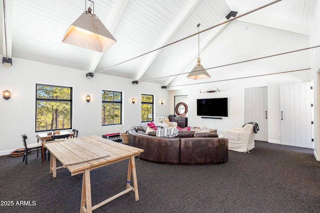 living area with dark colored carpet, baseboards, beam ceiling, and a wealth of natural light