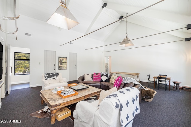 living room with visible vents, baseboards, high vaulted ceiling, and beamed ceiling