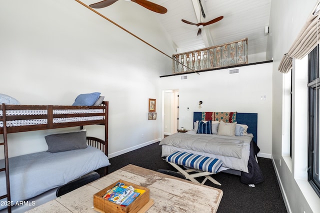 bedroom featuring visible vents, baseboards, high vaulted ceiling, and carpet