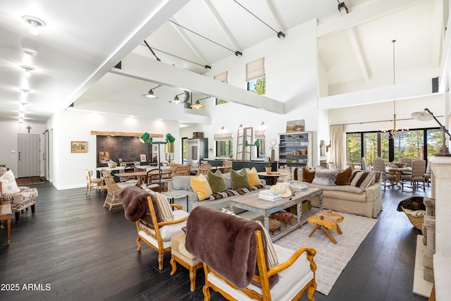 living area featuring beamed ceiling, high vaulted ceiling, wood-type flooring, baseboards, and a chandelier