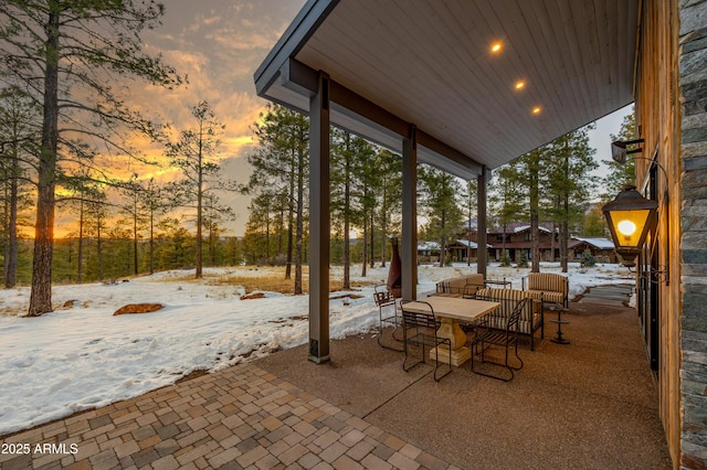 patio terrace at dusk featuring outdoor dining area