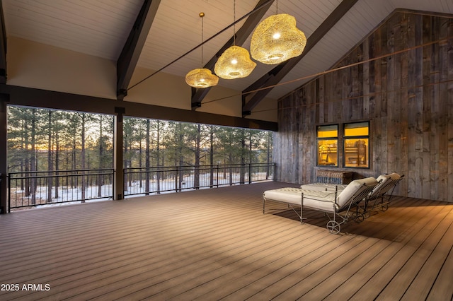 unfurnished sunroom featuring lofted ceiling with beams