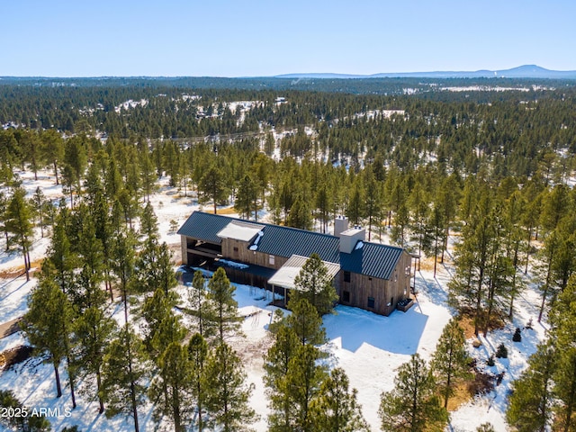 drone / aerial view with a mountain view and a forest view