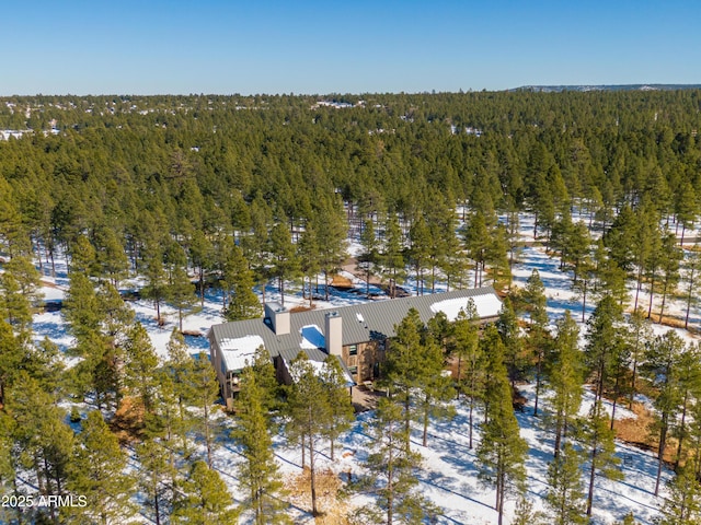 drone / aerial view featuring a wooded view