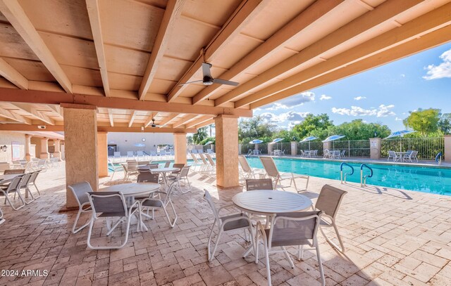 view of swimming pool featuring a patio area and ceiling fan