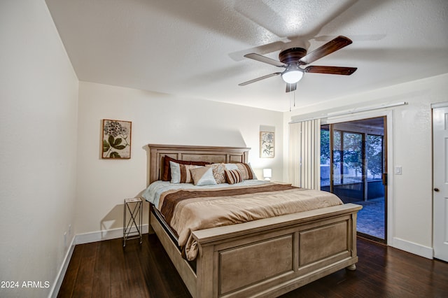 bedroom with access to outside, ceiling fan, dark hardwood / wood-style flooring, and a textured ceiling