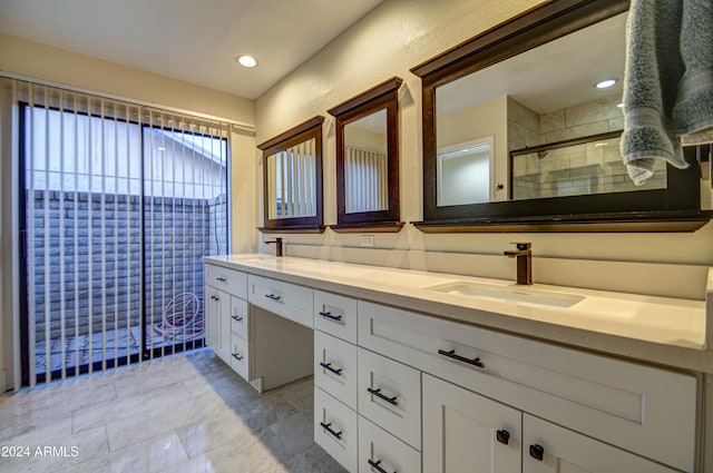 bathroom featuring vanity and an enclosed shower